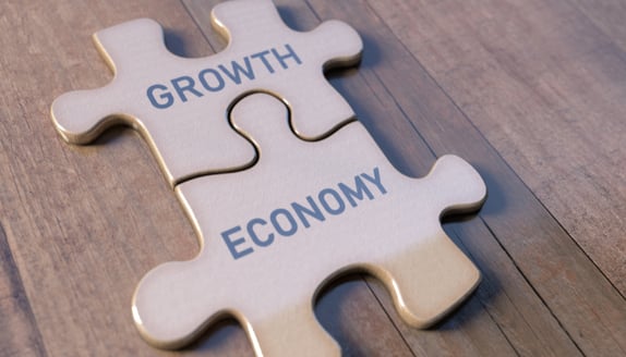 Puzzle pieces labeled “Growth” and “Economy” connecting together, symbolizing how lending partnerships support small business expansion.