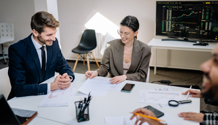 Business professionals reviewing financial documents together while discussing funding and working capital options.