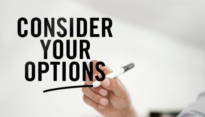 Hand holding a marker underlining the words “Consider Your Options” on a clean, blurred background.