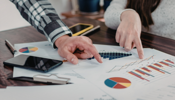 Owners reviewing financial statements to evaluate performance and long-term cash flow stability