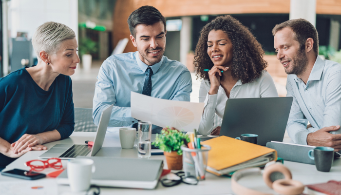 Team reviewing financial reports to assess current cash position and operating expenses