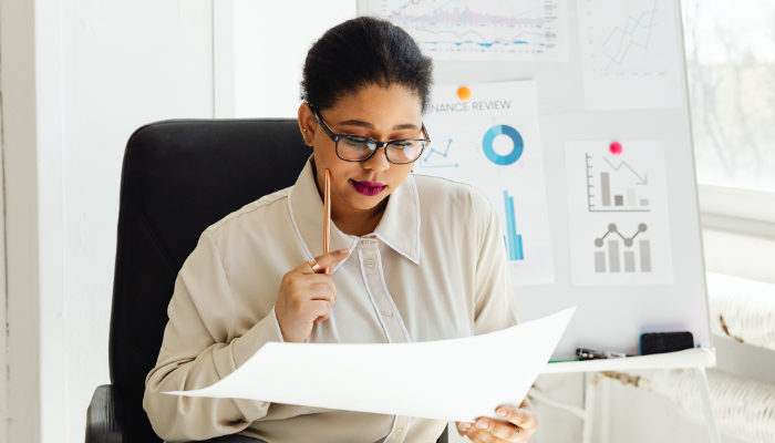 Owner reviewing financial statements to evaluate performance and long-term cash flow stability