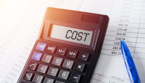 Calculator displaying cost while reviewing financial records and business expenses related to cash flow management.