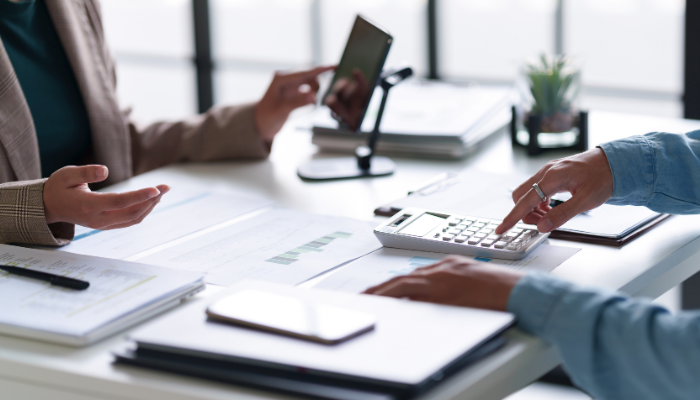 A professional exchanging a payment card, representing the step of separating personal and business finances to establish financial credibility.