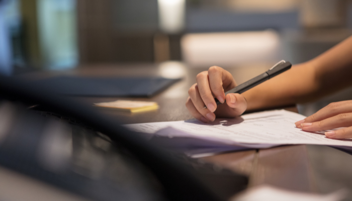A person reviewing official business documents, representing formal registration and setting up a company for financial legitimacy.