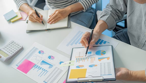 Business professionals reviewing reports and charts together to improve payment visibility and decision-making
