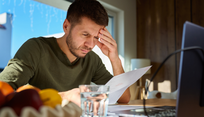 Business owner studying paperwork before deciding whether a new business opportunity makes financial sense