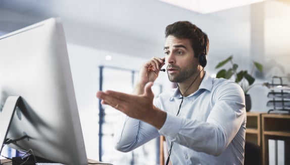 Business owner handling customer pushback on invoice factoring payment redirect by phone