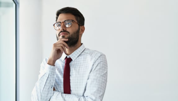 Business professional thoughtfully considering how accounts receivable financing could support cash flow