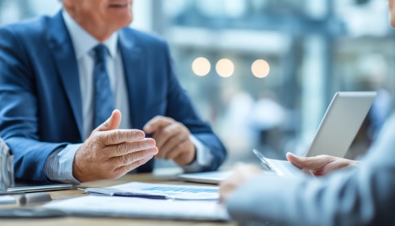 Experienced invoice factoring advisor explaining customer communication process to a small business owner