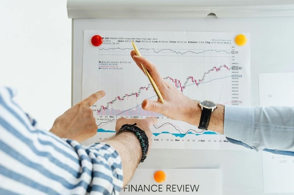 Executives reviewing financial charts to analyze trends, liquidity, and business performance