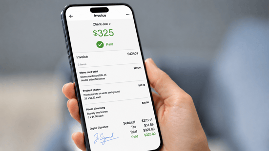 Mobile device displaying a paid invoice, illustrating how small business invoice factoring converts outstanding receivables into working capital.