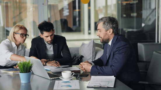 Business owners meeting with an invoice factoring partner to evaluate funding options, cash flow strategies, and working capital solutions for business growth.