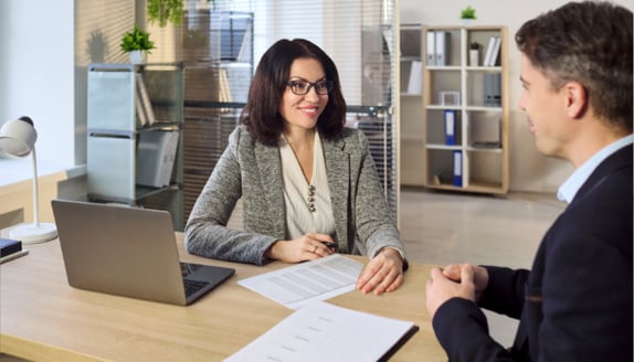 Two business professionals reviewing paperwork during a factoring-related payment process update