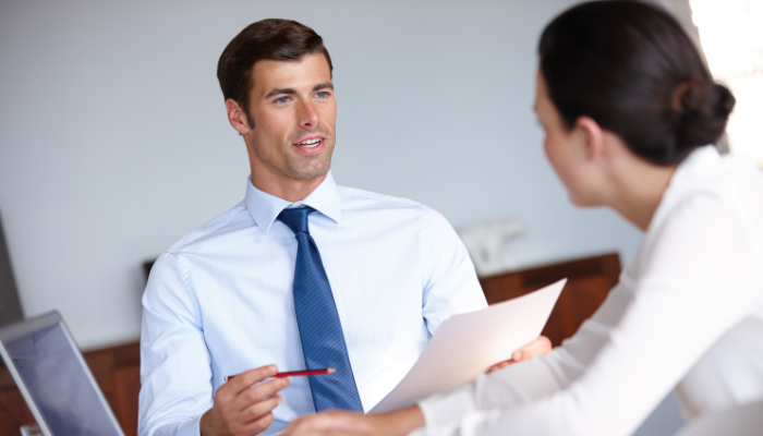 Two business professionals discussing financial details before deciding on accounts receivable financing